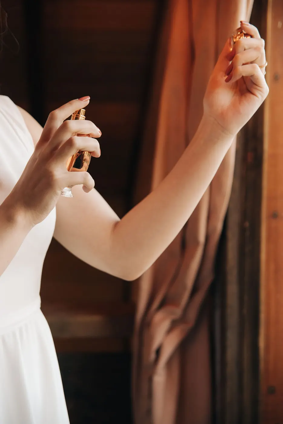 A woman spraying perfume on her wrist